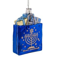 a hanukkah ornament hanging from a blue bag filled with gifts