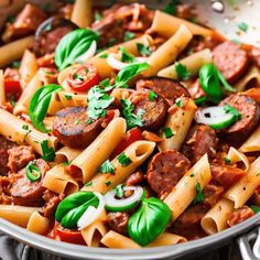 pasta with sausage, tomatoes and basil in a pan