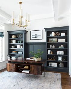 a living room filled with lots of furniture and bookshelves next to a window