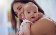 a woman holding a baby in her arms