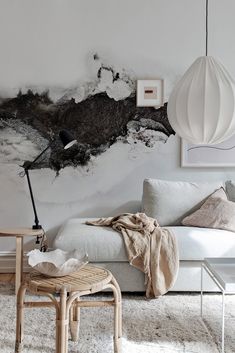 a living room with a couch, chair and wallpaper on the walls in black and white