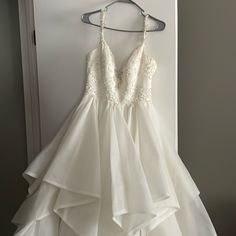 a white dress hanging up on a hanger