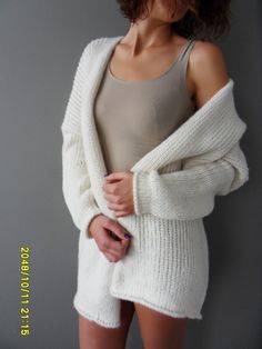 "Luxury, amazingly soft, oversized alpaca knit sweater cardigan . The pattern has relaxed fit with dropped shoulders. Color is off white. For colors available in pearl /light grey, black/charcoal, brown, crem/wheat, blue /green, burgundy, violet and pink click here https://www.etsy.com/ca/listing/187868895/alpaca-chunky-knit-woman-cardigan?ref=related-1 A new and exciting \"blow yarn\" made from soft 72% Baby Alpaca and cozy Merino wool. Its construction is unique, based on the newest yarn techn Long White Soft Knit Sweater, White Long Soft Knit Sweater, White Oversized Long Sweater Coat, White Long Oversized Sweater Coat, Oversized White Long Sweater Coat, Oversized White Soft Knit Cardigan, Oversized Soft Knit White Cardigan, White Oversized Cozy Sweater, Oversized White Cozy Sweater