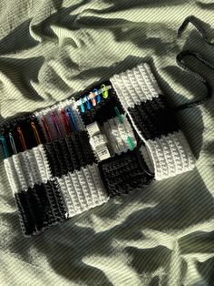 an assortment of pens and pencils are laid out on a blanket