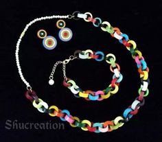 a multicolored necklace and earring set on a black background