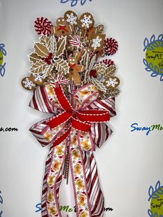 a bunch of cookies tied to a bow on top of a white board with snowflakes and candy canes