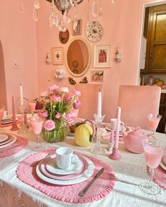 a dining room table with pink and white decor