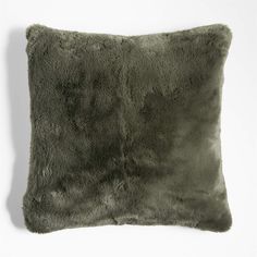 a square pillow with grey fur on it