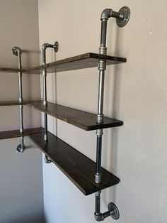 the shelves are made from metal pipes and wood