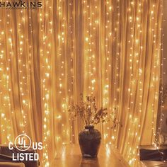 an image of a living room with lights on the curtains