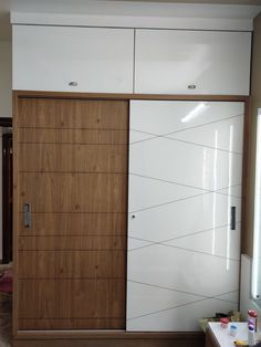 a white and brown closet with wooden doors