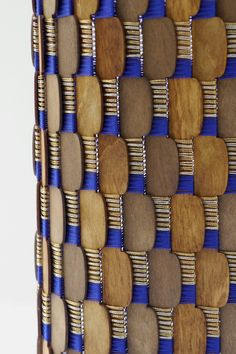 a blue and brown basket with wooden handles