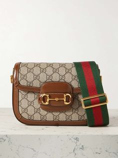 GUCCI Horsebit 1955 mini leather-trimmed printed coated-canvas shoulder bag | NET-A-PORTER Shop Gucci, Gucci Horsebit, Gucci Shoulder Bag, Print Coat, Brown Coat, Canvas Shoulder Bag, Dark Brown Leather, Net A Porter, Smooth Leather