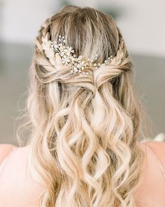 a woman with long blonde hair wearing a gold leaf headpiece in her hair and braid