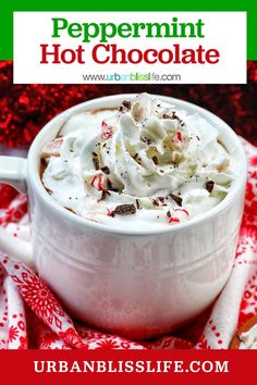 peppermint hot chocolate in a white mug with whipped cream and candy canes