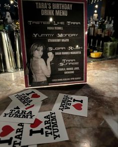 some cards are laying on the floor in front of a sign that says, tab's birthday drink menu