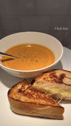 a bowl of soup and grilled cheese sandwich on a plate