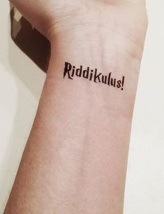 a wrist tattoo with the word riddikulus on it's left arm