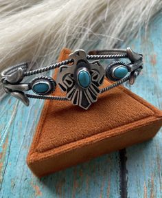 Loving this wonderful Thunderbird piece. Sterling Silver with a Turquoise. Measures 1 inch wide, 5 1/2 inch inside circumference and an adjustable 1 inch gap. The bracelet is stamped Sterling and signed. WILL VARY Thank you for looking at our items. Please contact us if you have any questions. Western Style Bangle As Gift, Western Style Bangle Jewelry As Gift, Western Style Bangle Jewelry Gift, Western Style Blue Bangle Jewelry, Western Style Bracelet Jewelry Gift, Silver Smithing, Navajo Turquoise, Turquoise Cuff, American Jewelry