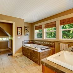 a bathroom with a large jacuzzi tub next to a toilet and sink in it