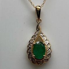 Set Securely In The Center Of The Pendant A Natural Emerald Gemstone. The Emerald Measures 7 X 5mm And Weighs Approximately 0.80 Carats. It Has A Medium Green Color With Only Natural Inclusions. The Gemstone Is Surrounded By A Yellow Gold Braided Detail And Then A Full Row Of Small White Diamonds. The Diamonds Are Set In A Scalloped Halo Design. The Total Diamond Weight Is 0.10ct Twt. There Is A Large High Polished Bail At The Top That Allows The Emerald And Diamond Pendant To Swing Freely. It M Emerald Pendant Necklace 1stdibs, Emerald Beads Jewelry Indian Pendant, Gold And Diamond Pendant, Black Gold Necklace, Dainty Accessories, Dainty Initial Necklace, Blue Stone Necklace, Gold Pendants, Pearl Necklace Designs