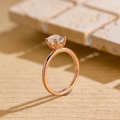 a diamond ring sitting on top of a wooden table