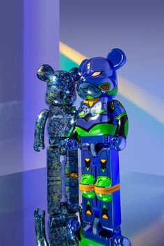 a blue and green bear standing next to a tall sculpture