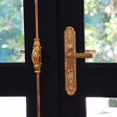 an open door with a handle on it and a glass window in the back ground