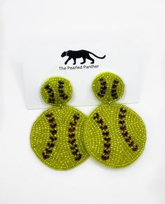 two green and red beaded earrings with a black cat on the front, one in the