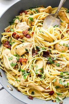 pasta with chicken, bacon and parsley in a skillet