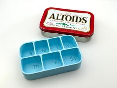 an altoids lunch box with compartments and the lid open