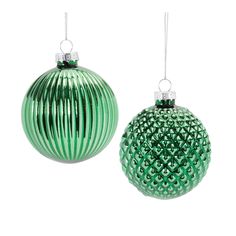 two green christmas ornaments hanging from chains