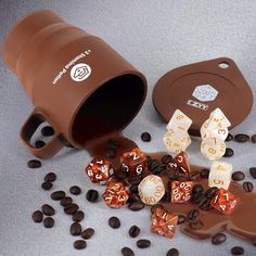 coffee beans and dice are spilled out of a cup