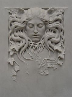 an intricately carved face on the side of a building