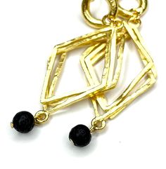 Satin Gold Plated Earring with Black Lava Drops- super chic with a contemporary vibe Dangle Drop Earring- created for the active woman who loves to travel and tuck something clever into her carry on Tiny Black Lava Beads- add the final touch that catches the eye and starts conversations Length of Earring Drop is 2 inches- designed as a casual chic accessory that makes a super sophisticated statement Lava Earrings, Lava Beads, Chic Type, Lava Bead, Final Touch, Chic Accessories, Drop Earring, Modern Chic, Gold Plated Earrings