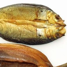 two dried fish sitting next to each other on a white surface