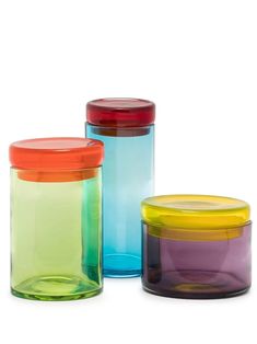 three different colored glass containers with lids