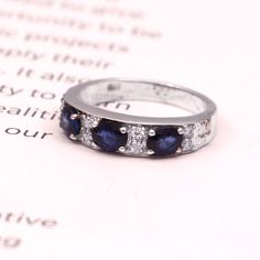 This Sterling Silver Ring features an Elegant Art With Natural Blue Sapphire Gemstone. The cavity is made from genuine solid 925 sterling silver and stamped as S925. This Jewelry is Lead free and Rhodium plated. ITEM DESCRIPTION Item Code: JARG107 Metal: 925/92.5 Sterling Silver Gemstone: Genuine Natural Blue Sapphire (diffusion) Faceted (Handcrafted) Gemstone Shape: Oval Gemstone Size: 4 X 5 MM Secondary Stones: Zircon (small white stones) Weight: 3.40 gm approx (17 Carat approx) **Keep the jew Classic Multi-stone Sapphire Ring With Cubic Zirconia, Vintage Sapphire Three-stone Jewelry, Elegant Square-cut Sapphire Ring In Sterling Silver, Sterling Silver Multi-stone Sapphire Gemstones, Luxury Three-stone Sapphire Ring In Sterling Silver, Art Deco Sapphire Ring, Natural Blue Sapphire, Blue Sapphire Rings, Three Stone Rings