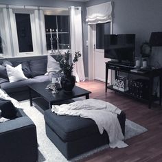 a living room filled with furniture and a flat screen tv