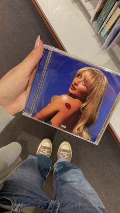 a person holding up a cd in their hand