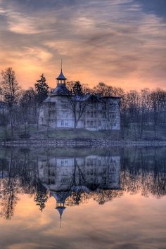 a large building sitting on top of a lake