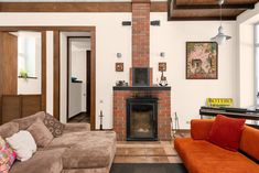 a living room filled with furniture and a fire place