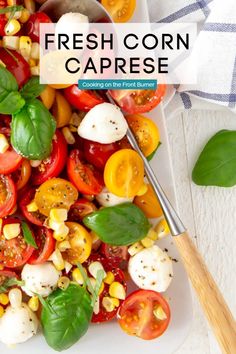 fresh corn and tomato caprese on a white plate with a wooden serving spoon