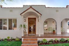 the front entrance to a home with steps leading up to it