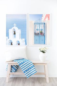 two pictures hang on the wall next to a bench with a blue and white blanket