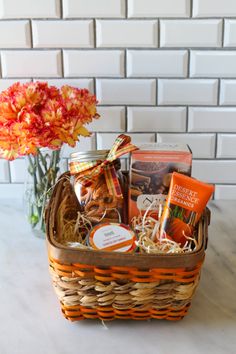 a basket filled with treats and flowers on top of a table