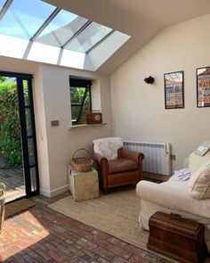 a living room filled with furniture and a skylight