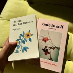 there are two books on the couch one has a flower and the other is a note to self