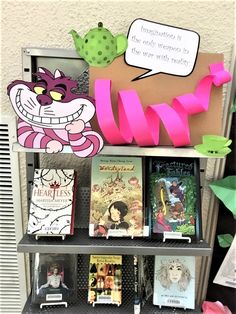 a book shelf with several books on it and some paper cutouts hanging from the shelves