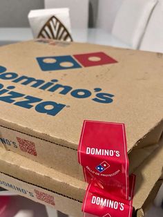 two domino's pizza boxes stacked on top of each other